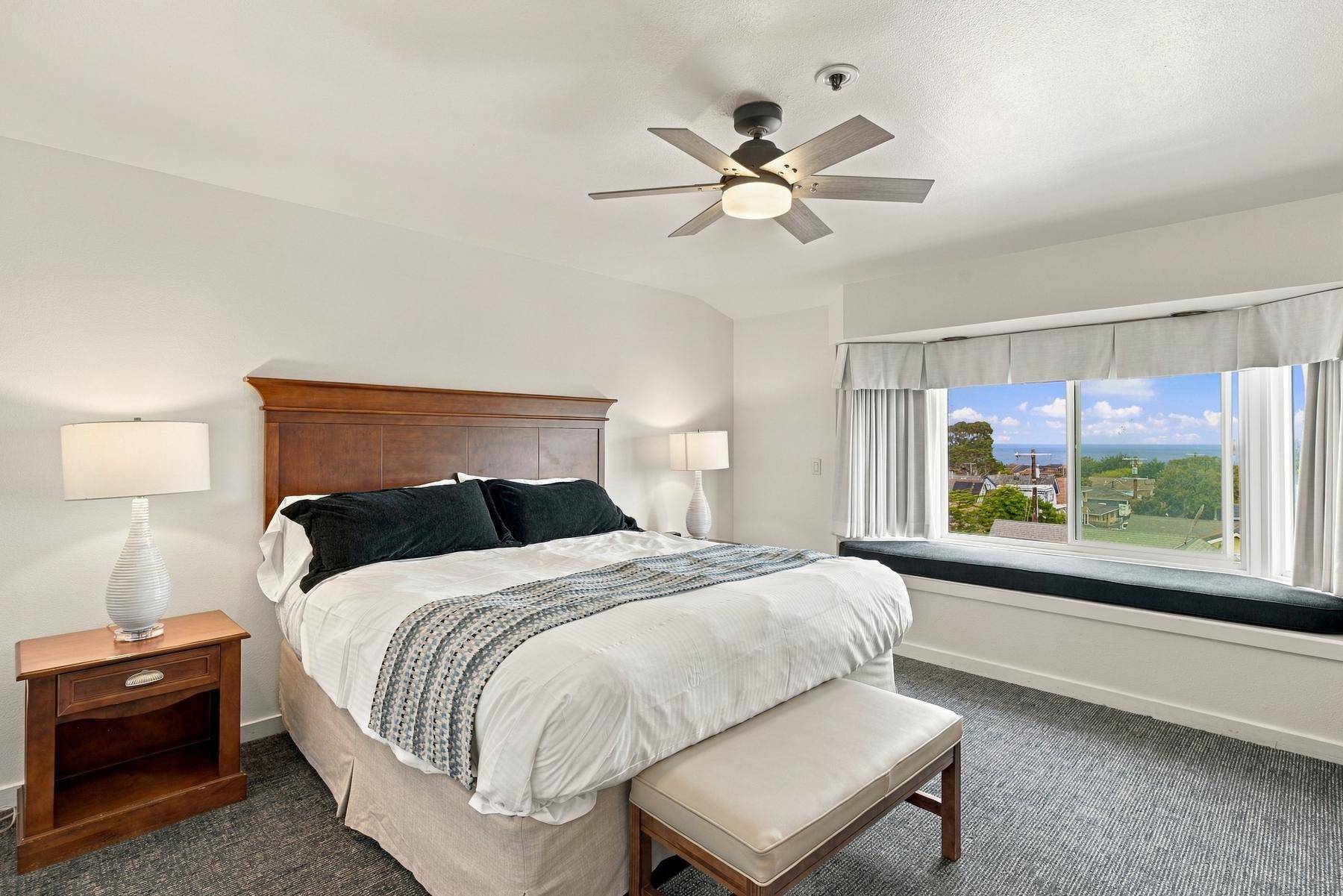 Unit B-2 master bedroom with a window seat and bay view