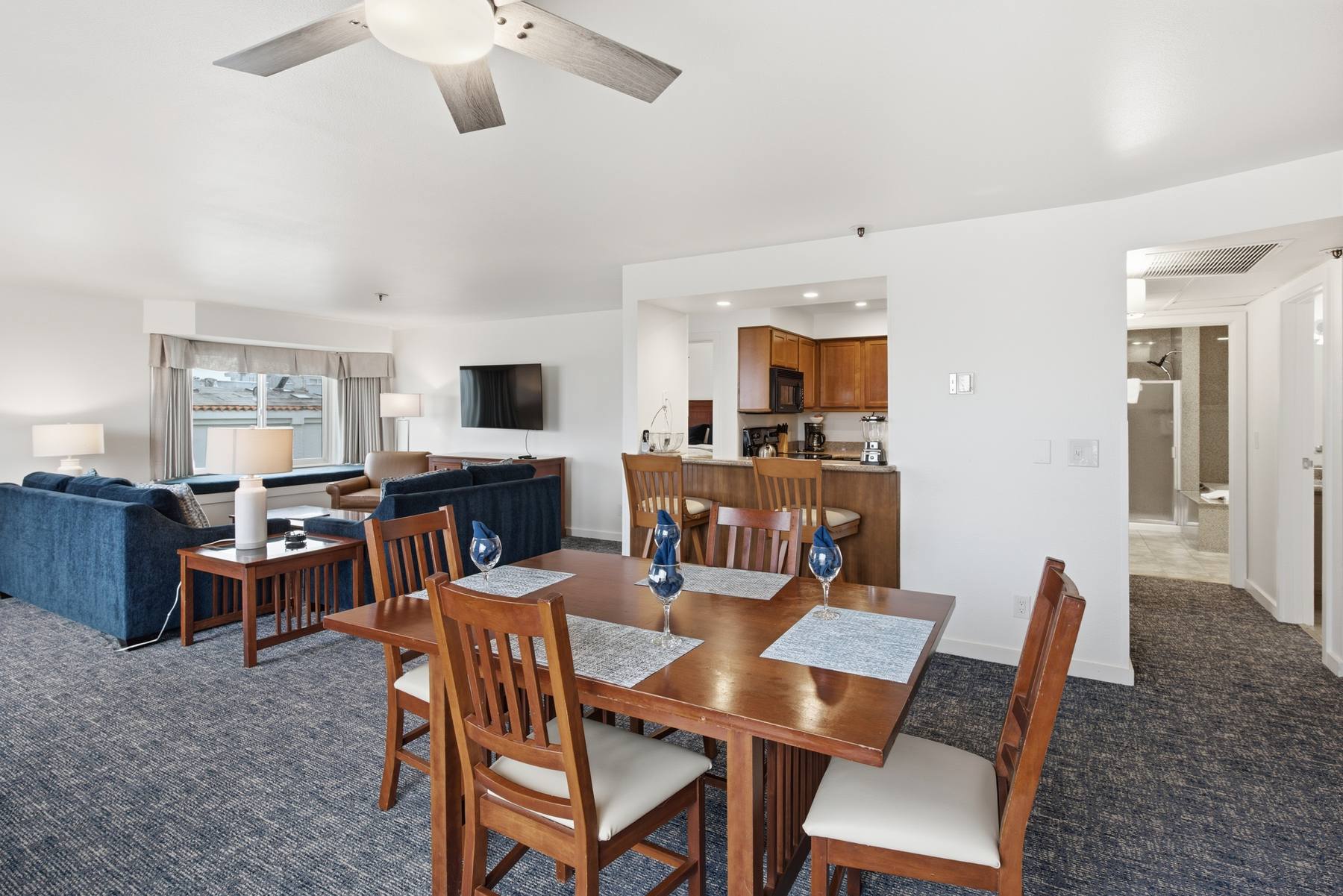 Penthouse kitchen and dining table with the living room beyond