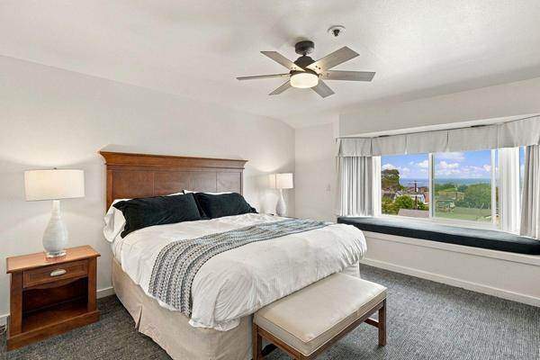Master bedroom with a window seat and bay view